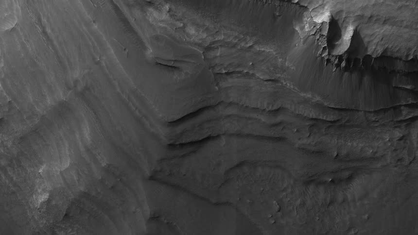A rugged and gray terrain is seen from above
