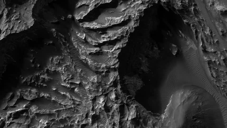 Top down aerial view a rugged deserted terrain shot in black and white