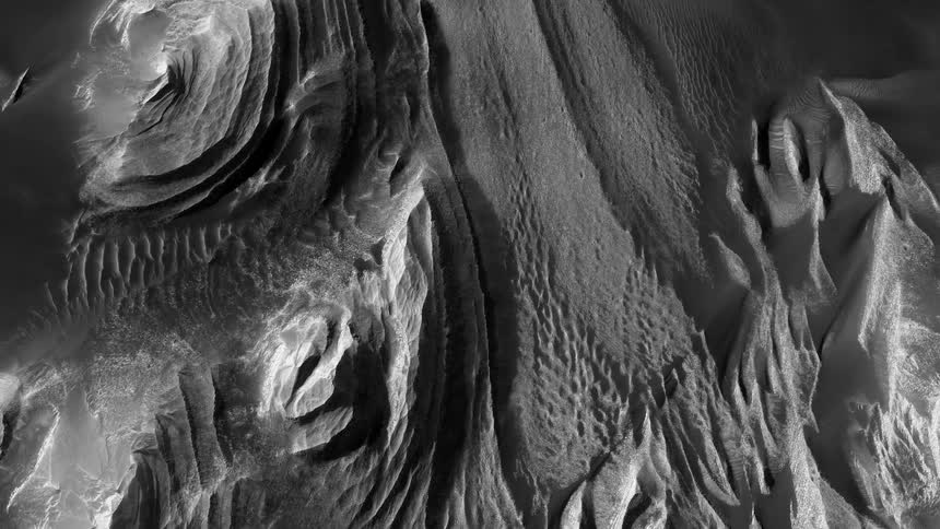 A rugged and mountainous terrain is seen from above