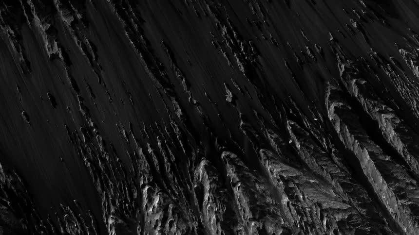 Overhead view of the rough terrain of a barren planet