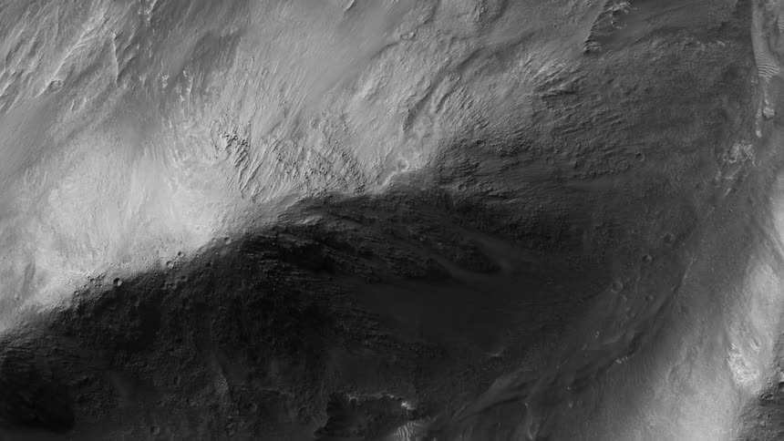 Aerial view flying over the rough barren surface of a planet