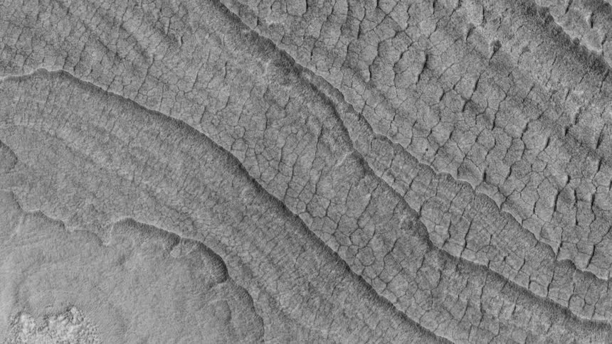 From above is the view of what looks to be the terrain of another planet in outer space