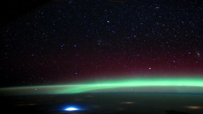 Time lapse of the view of cities and glowing atmosphere over planet earth seen from low orbit