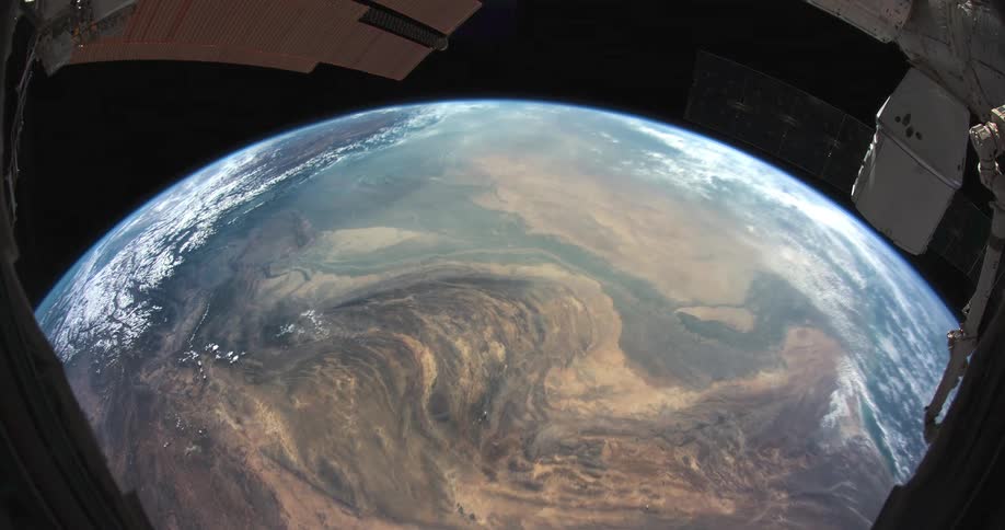 A satellite or space station traveling over a revolving planet earth