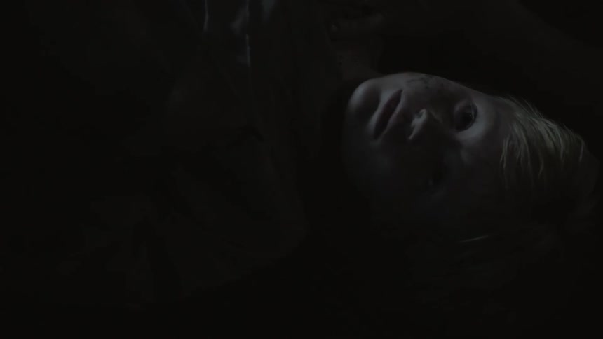 A man is laying on the floor in a dark room