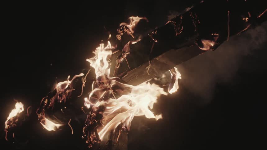 A large cross is burning at night
