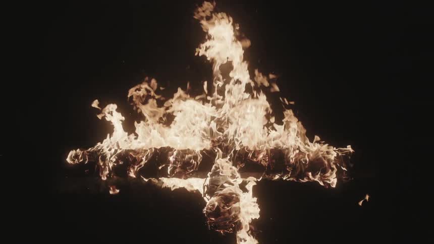 A burning cross at night
