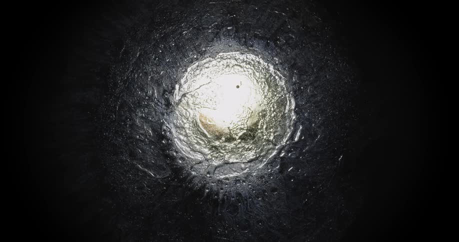 Glowing pale mixture spreads against a darker substance