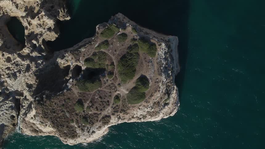 Interesting cliffs jut out into the deep green water
