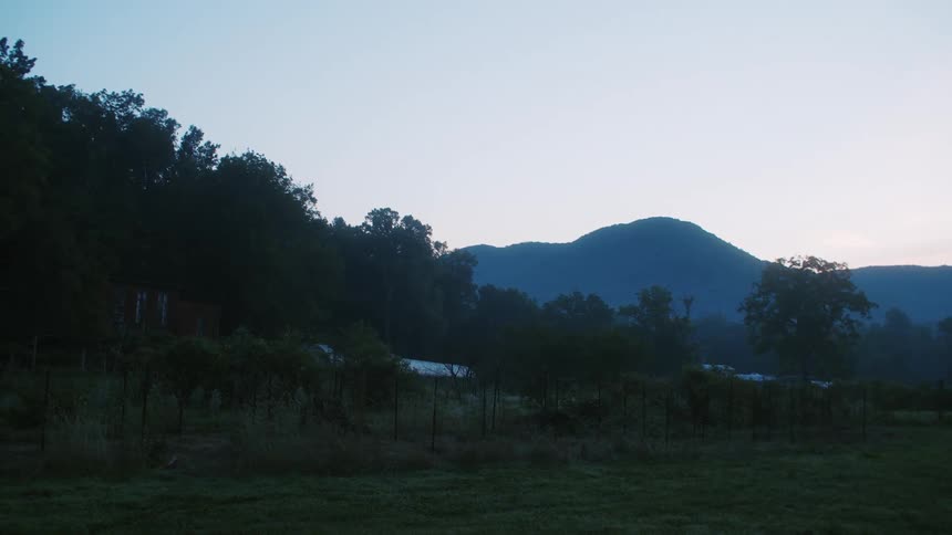 The sun is setting in the mountainous landscape