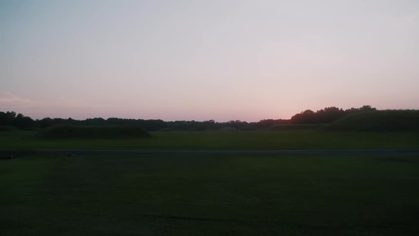 Slow pan across a field during sunset