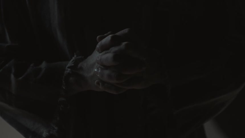 A person has their hands clasped together