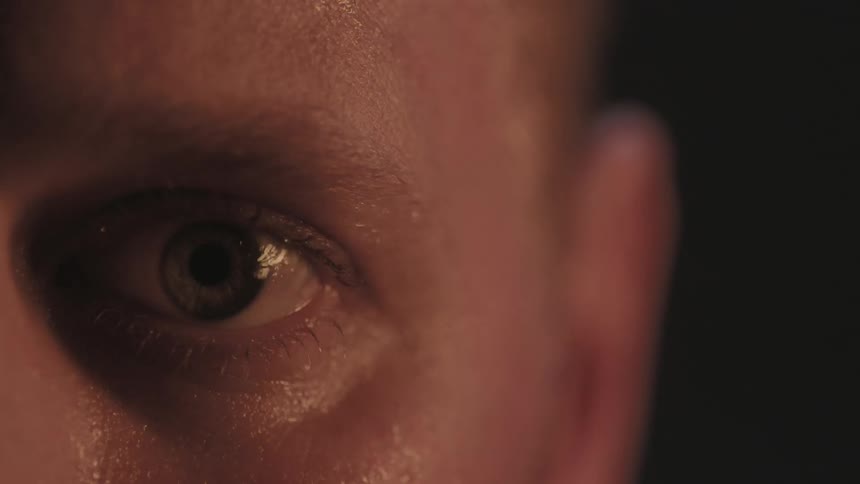 A person stares into a flickering fire