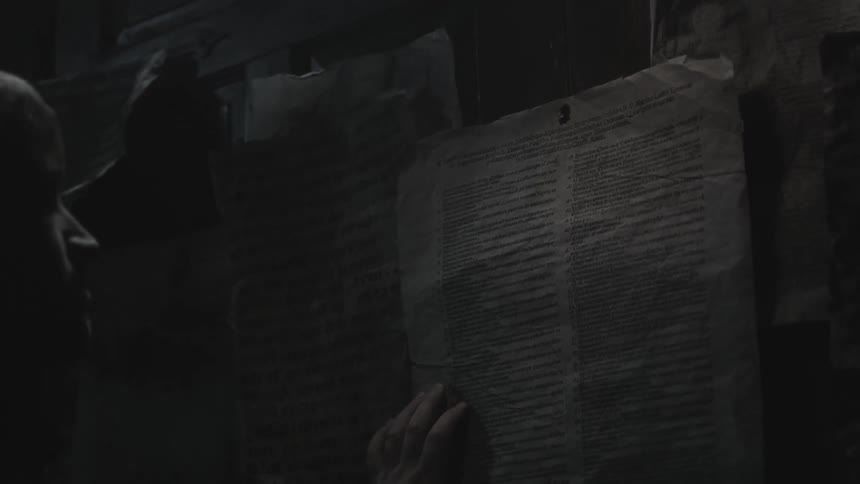 A man is hammering a notice to a wall