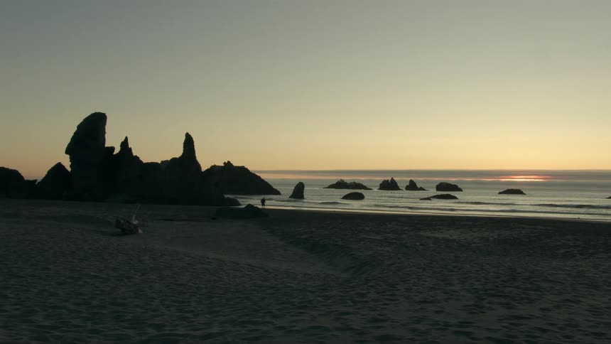Gentle waves ripple on the beach at dusk
