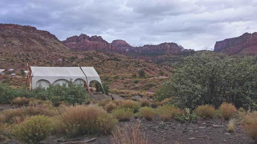 Tents set up in front of hills and canyons