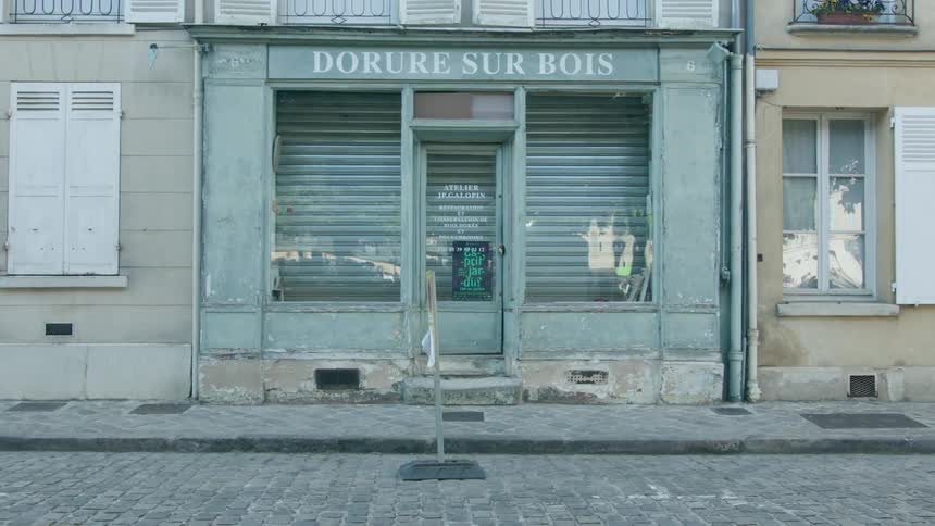 Exterior view of old light blue closed store in the street