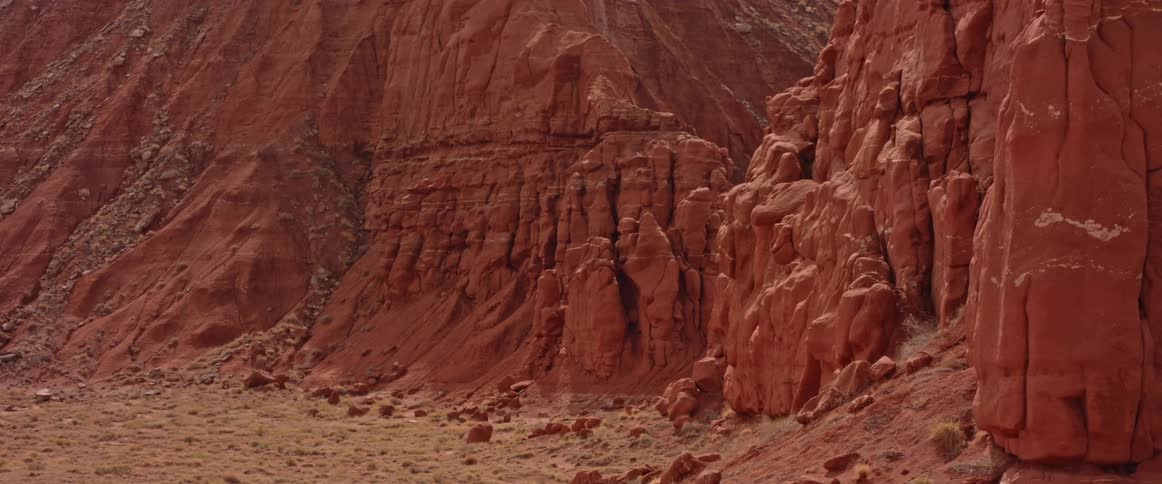 Broken pieces of rocks sit at the base of a canyon