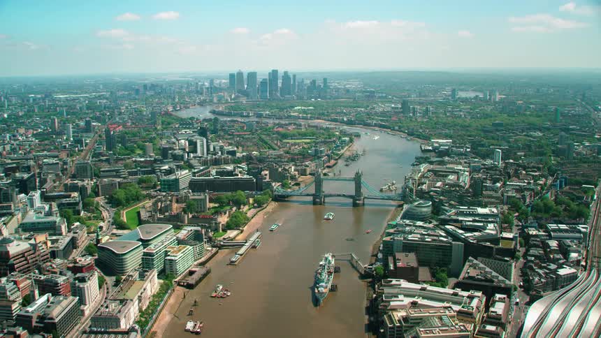 A murky river running through a metropolis during the day