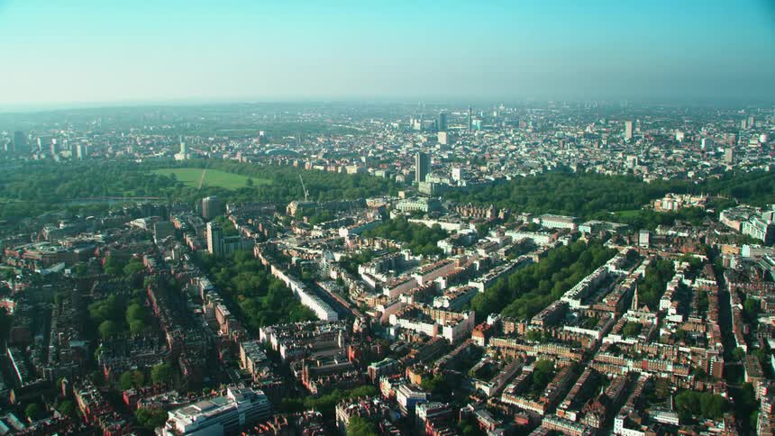 Aerial view of apartment buildings large public park and skyline in london