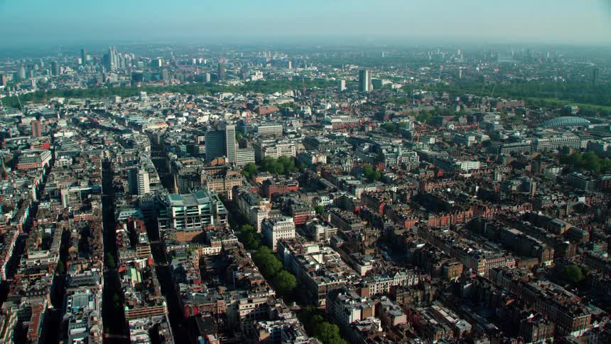 An aerial view of a dense city area with low rise buildings