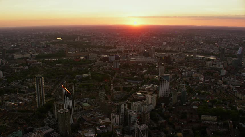 Orbiting aerial view of the skyscrapers and buildings in london skyline at sunset