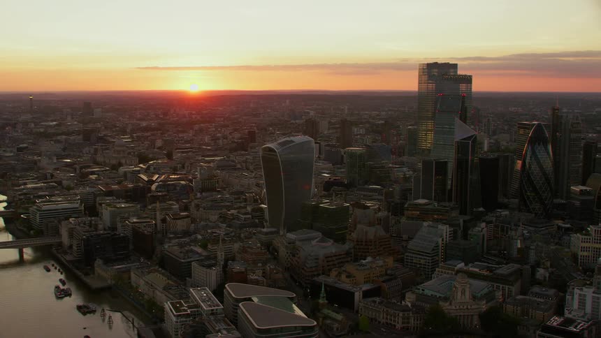 Aerial view of skyscrapers and office buildings near river thames in city of london