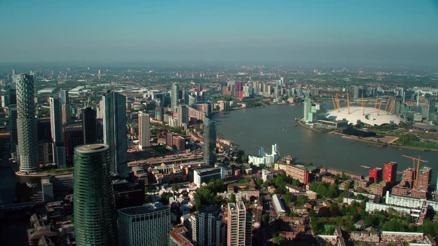 River water moves among skyscrapers in channels on foggy day