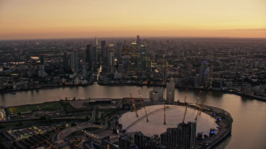 Aerial view of river thames with boats and skyline in london at dusk
