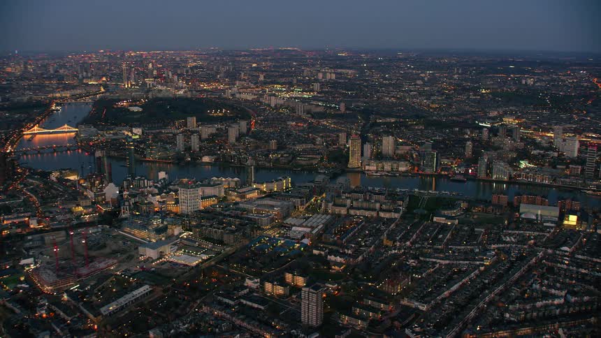 Aerial view of a downtown city during sunset is displayed