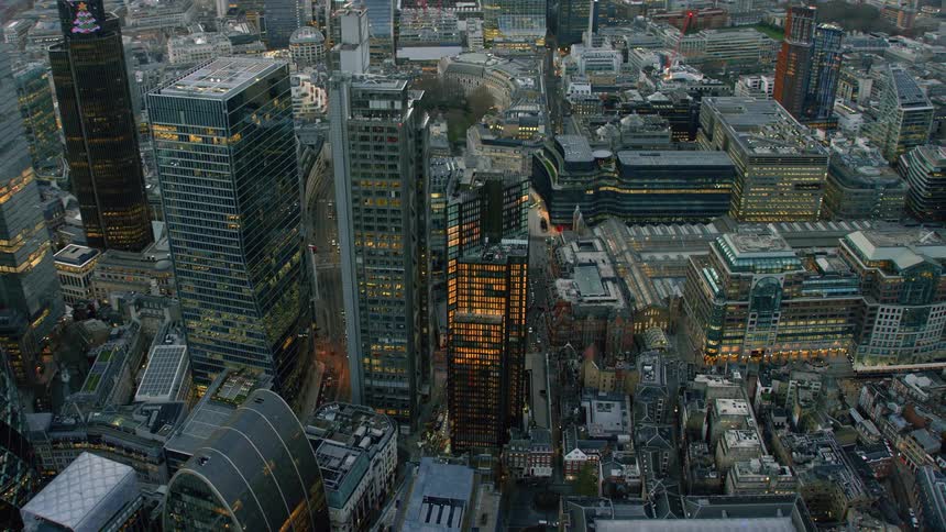 A downtown cityscape with many buildings lit up