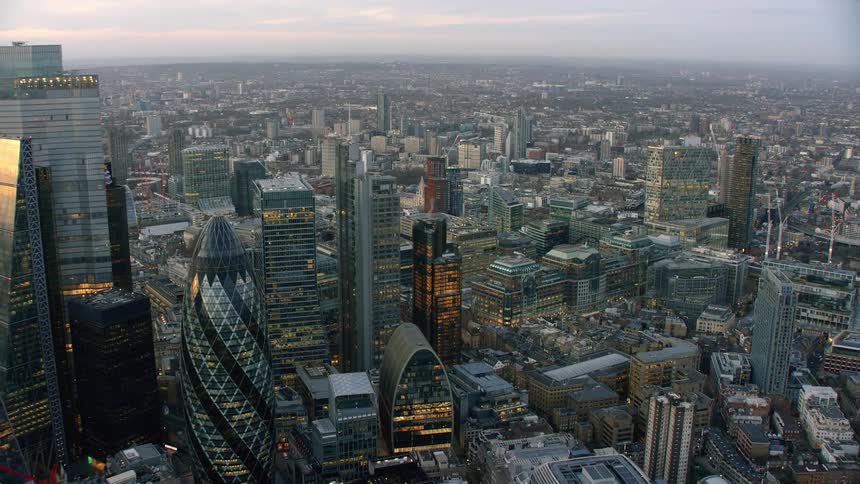 Aerial view of a dense city with tall buildings and unique architecture