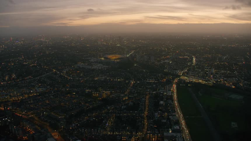 Aerial view of a downtown city during sunset is displayed
