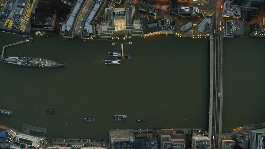 Top down aerial view of the thames river flowing through the city of london