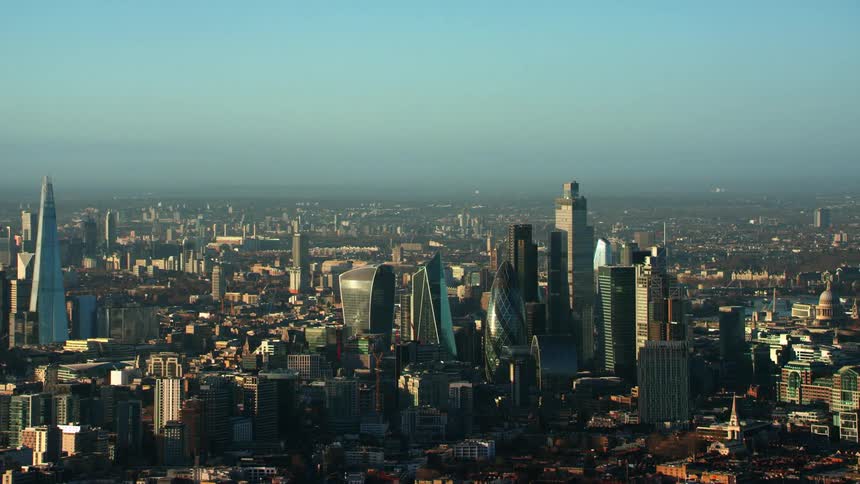 Aerial view of skyscrapers and high rise buildings at dusk in the city