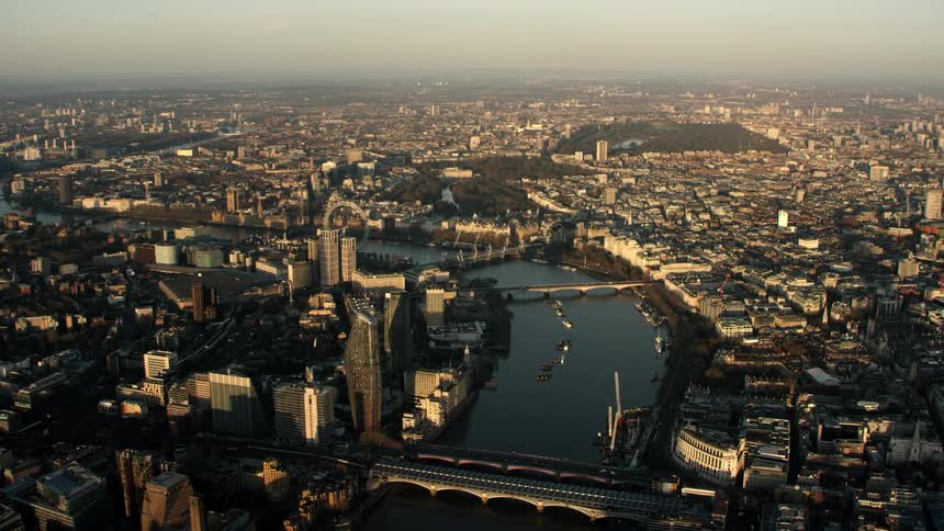 Aerial view of large city with buildings bridges over water