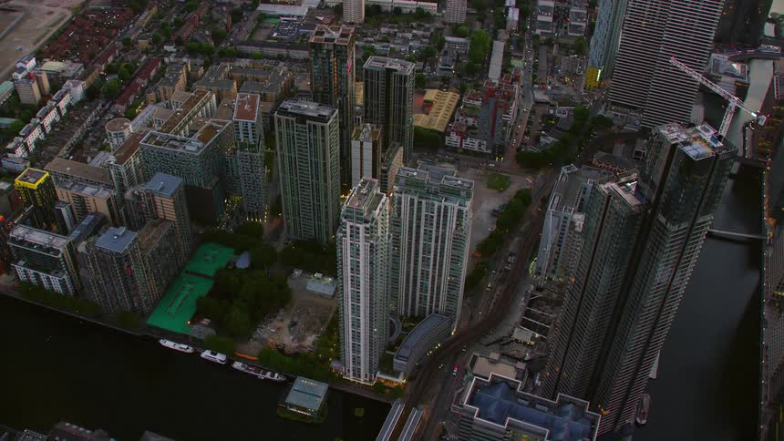 Aerial view of a city with tall buildings on the edge of water