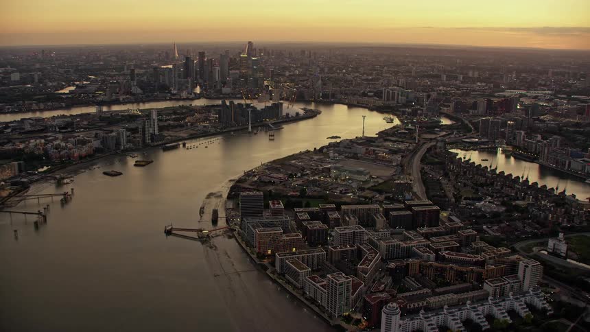 Aerial view of river thames with boats and skyline in london at dusk
