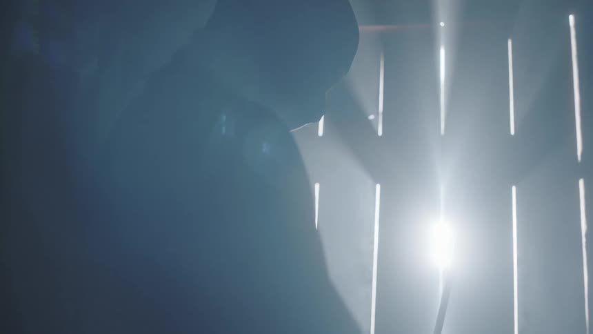 A man is holding a sword near a closed door