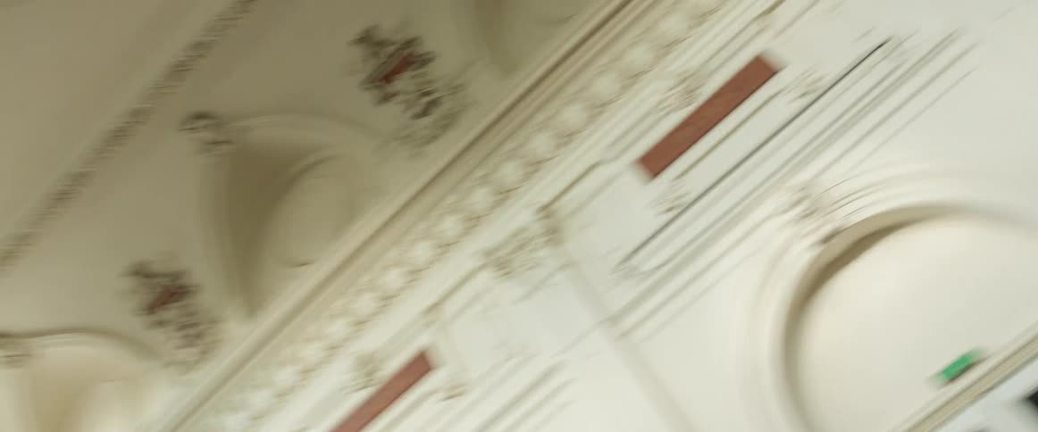 Beautiful architecture inside a building with red curtains hanging over arches