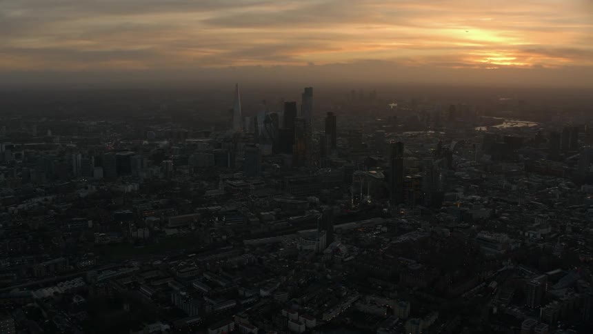 Aerial view of the sun setting above the urban city