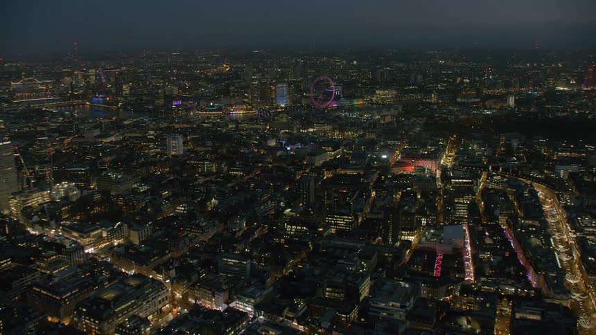 Aerial view of illuminated buildings and skyline in london at night