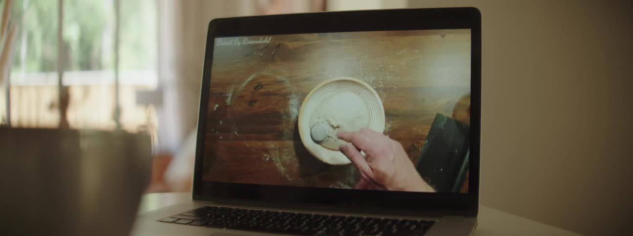 Cooking instructional video playing on a laptop on the kitchen at home