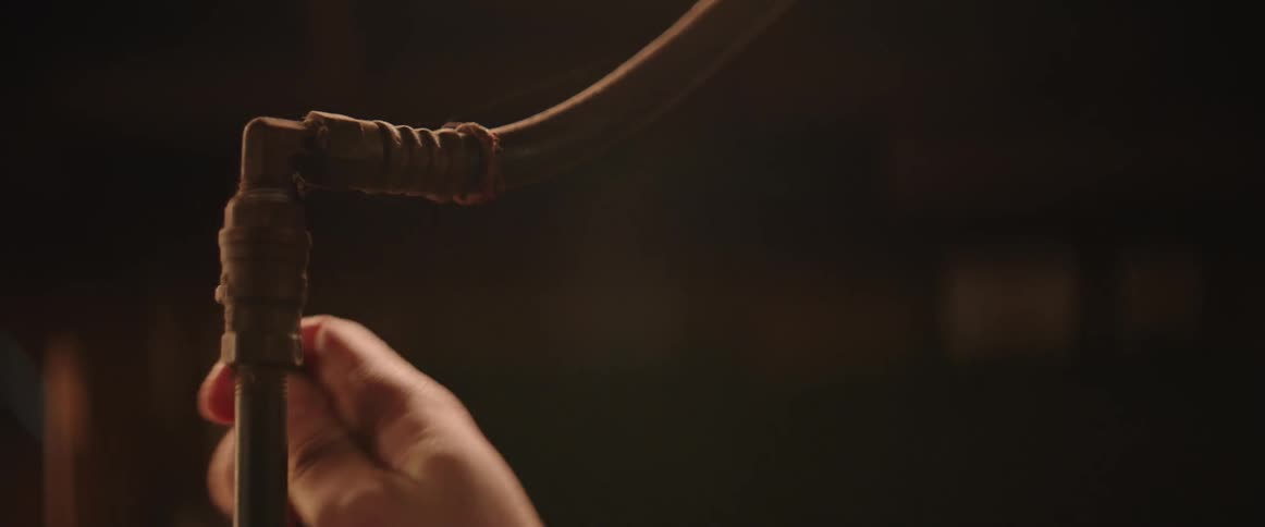 Close up of hand turning isolation valve