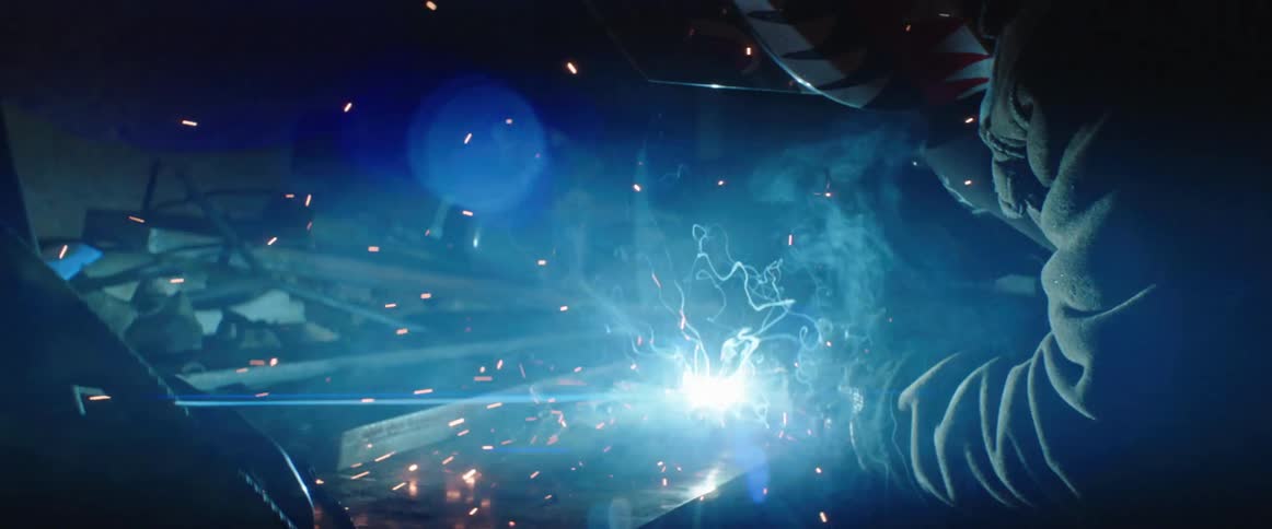 Person welding creating bright sparks from the metal