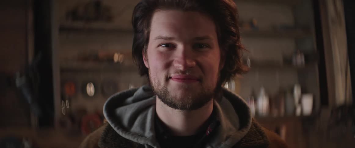 Portrait of young man in his blacksmith workshop