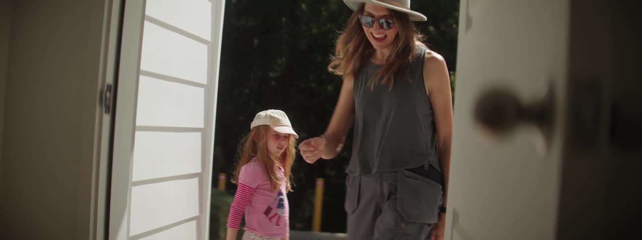 Mother and daughter high five each other before going out on a walk