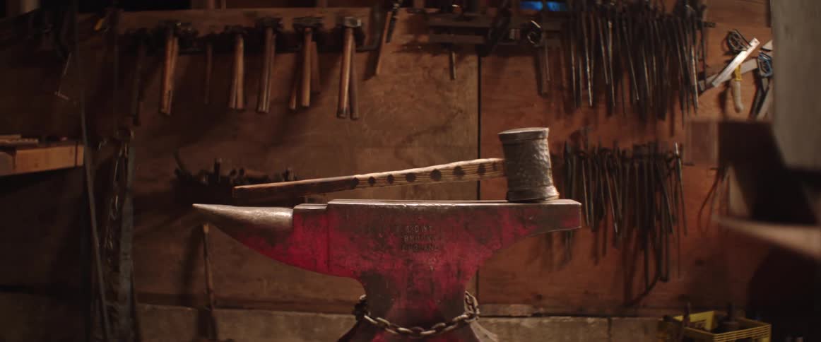 Hammer lies on anvil at blacksmith workshop
