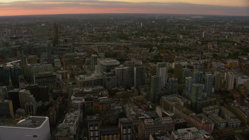 Aerial view of a downtown city during sunset is displayed