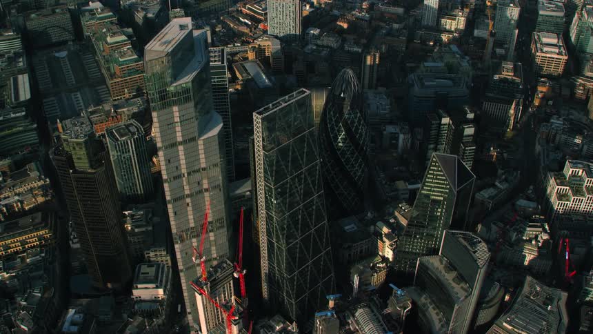 An aerial view of a city with multiple skyscrapers and unique architecture